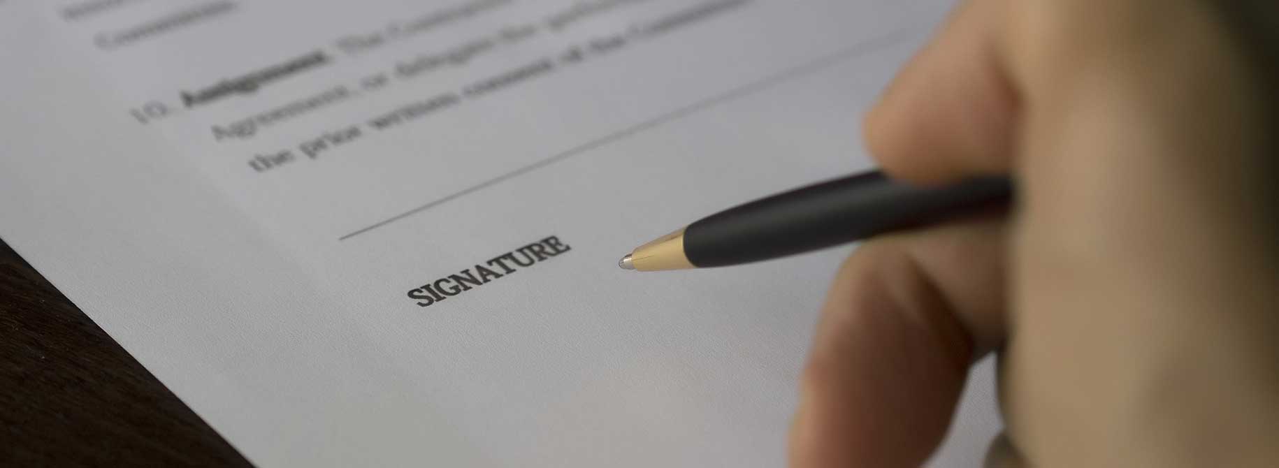 picture of a person signing an agreement picture of a person signing an agreement