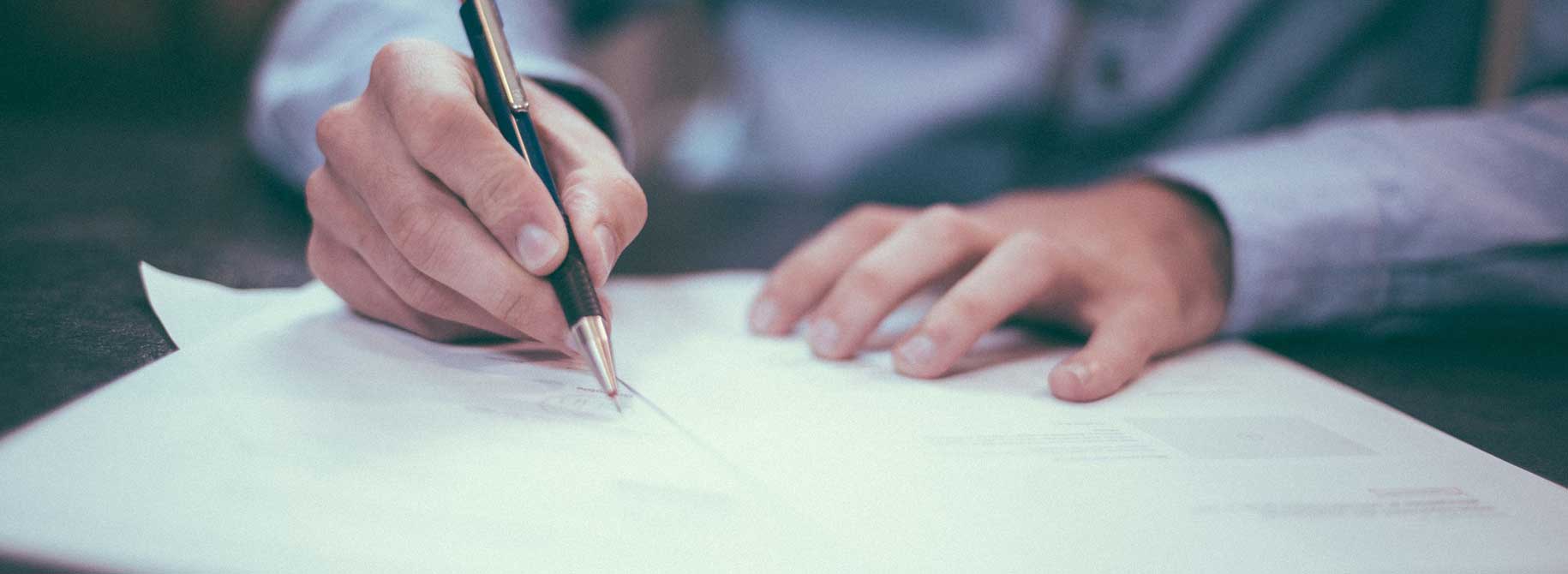 picture of a man signing contract