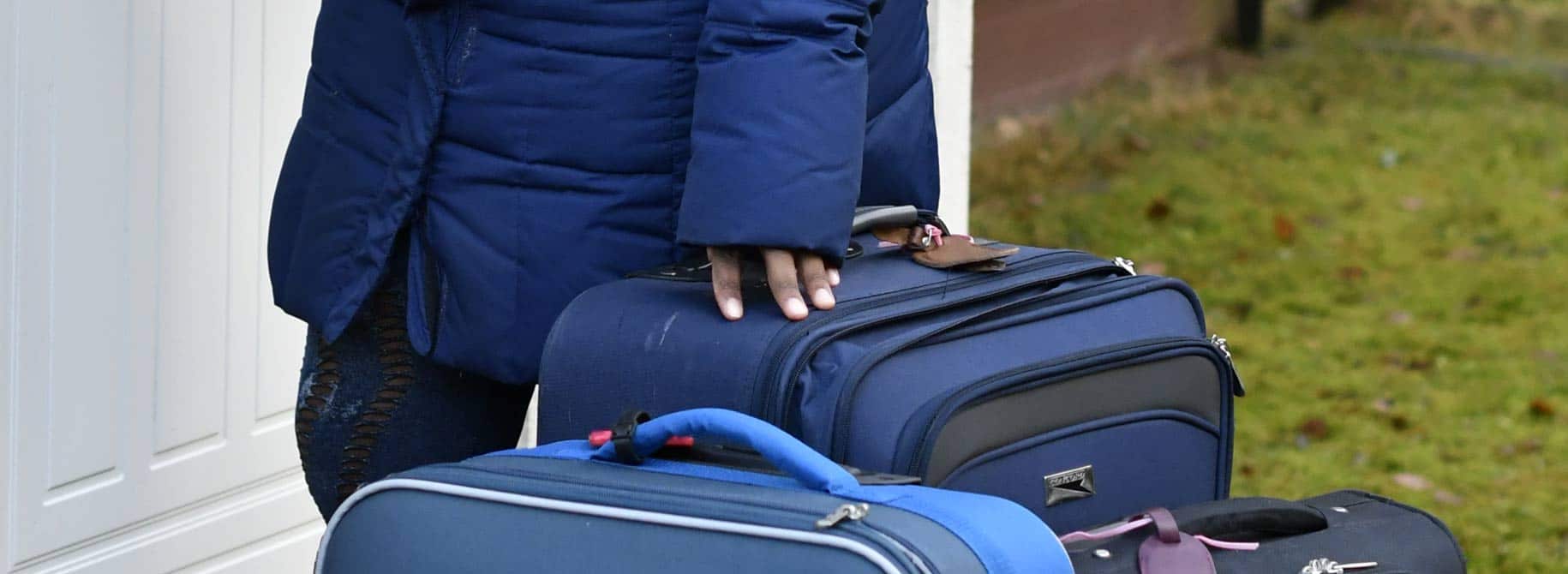 Nainen seisoo uuden kotinsa ovella