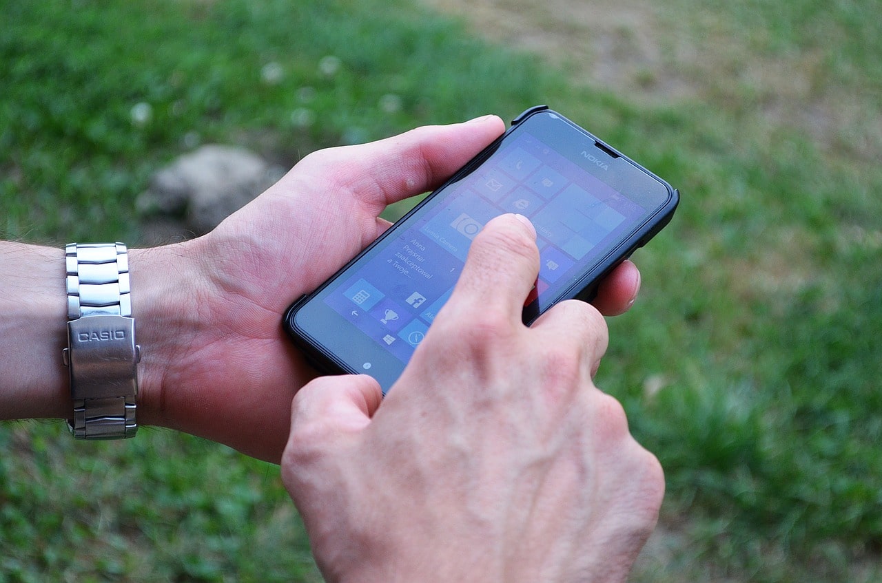 man tapping mobile