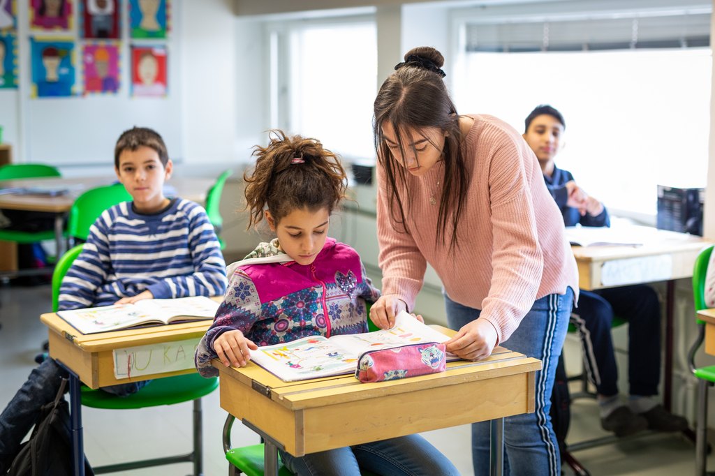 teacher and students in a classroom